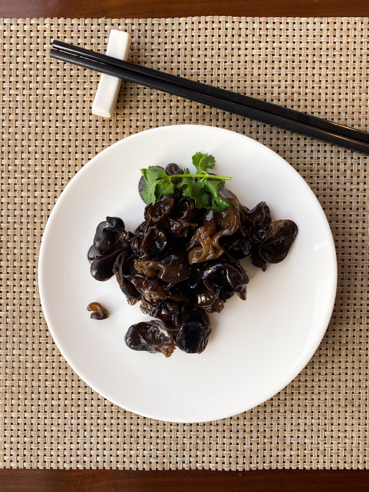 A plate with mushrooms and chopsticks on it, featured in a China 2023 report.